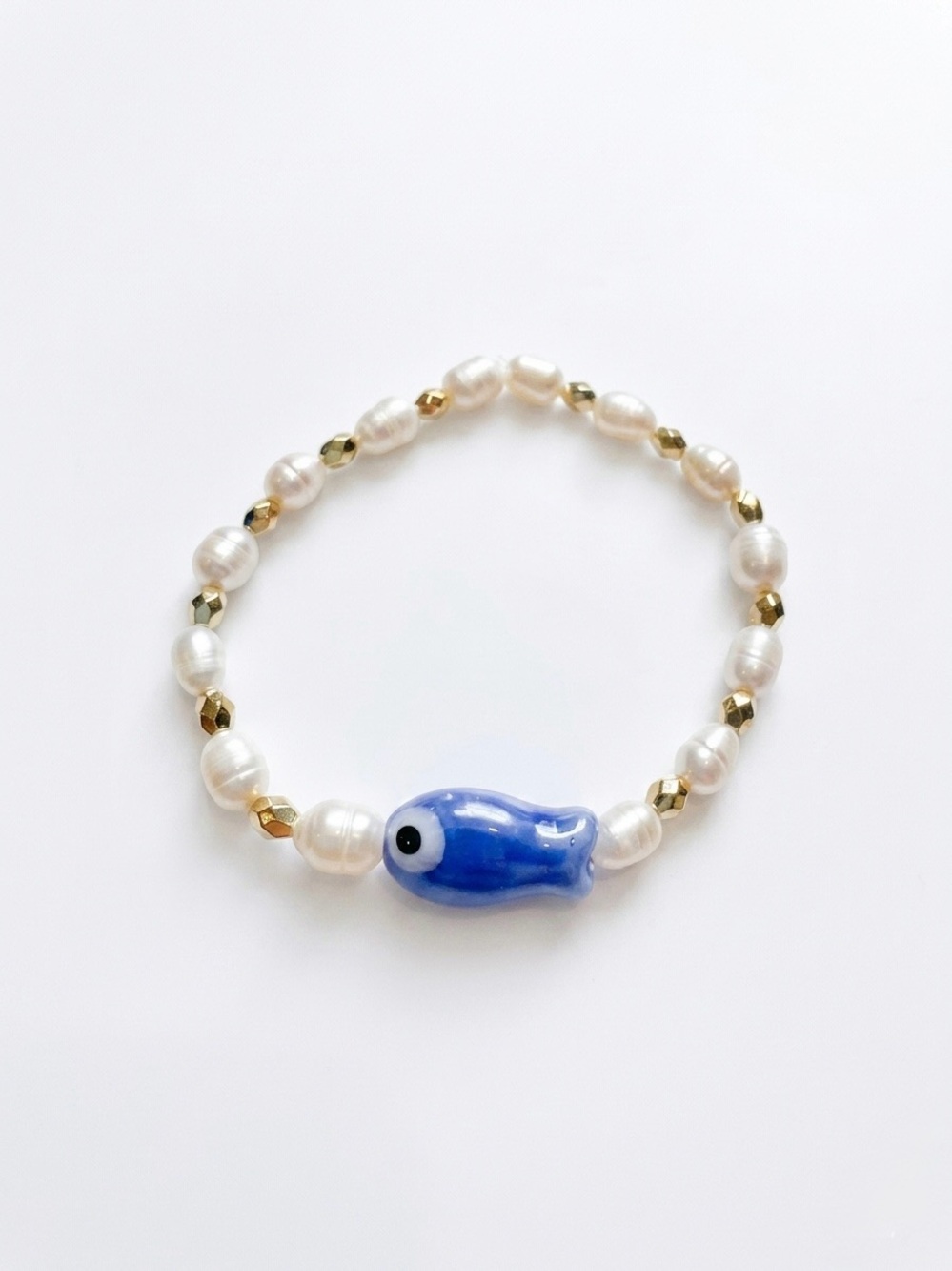 Pearl Bead Bracelet with Blue porcelain Fish Charm. Other colors available.